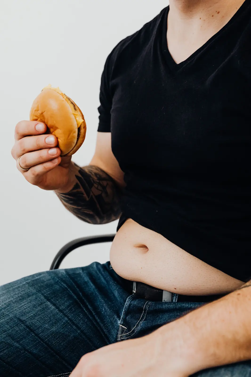 Holding a burger while seated