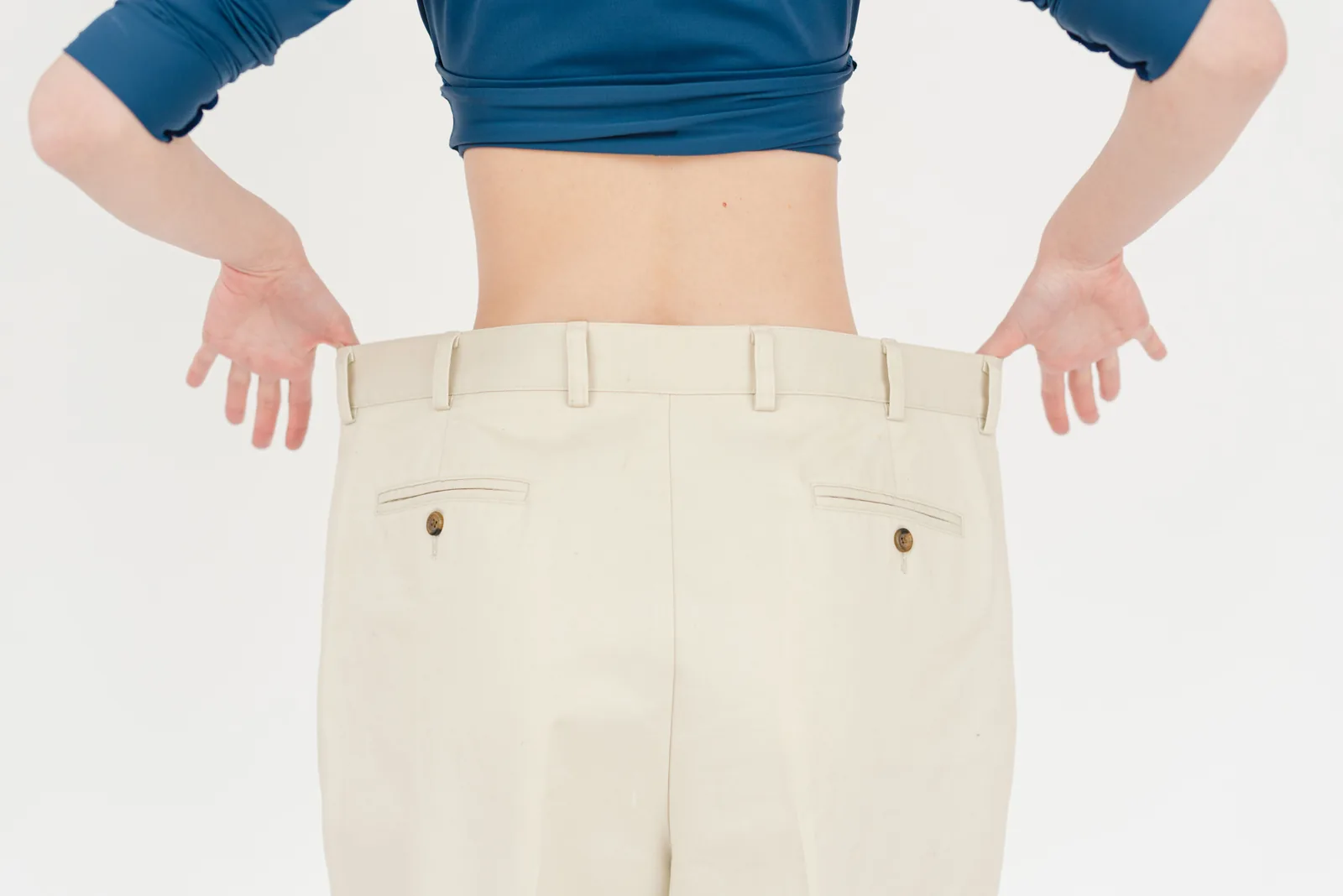 Oversized trousers held out at the waist